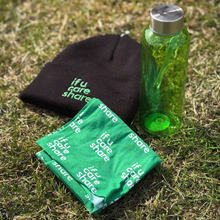 Load image into Gallery viewer, Black beanie, green towel, and green bottle on grass with &#39;if u care share&#39; text.