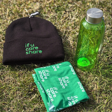 Load image into Gallery viewer, Black beanie, green towel, and green water bottle on grass with &#39;if u care share&#39; text.